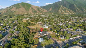 Aerial view of property's location featuring a mountain backdrop and nearby suburban area