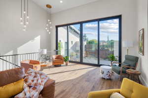 Living room featuring hardwood / wood-style floors and a towering ceiling