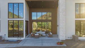 Entrance to property with outdoor lounge area and a patio area