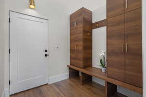 Mudroom with baseboards and wood finished floors