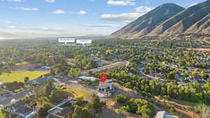 Aerial view of property's location featuring a mountainous background and nearby suburban area