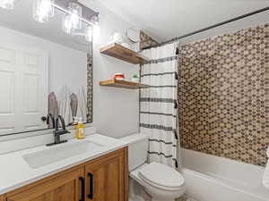 Full bath featuring vanity and shower / bath combo with shower curtain