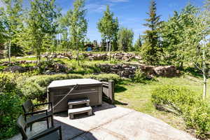 View of patio with a hot tub