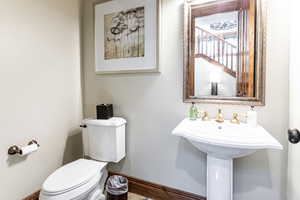 Bathroom with toilet and baseboards