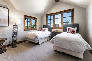 Carpeted bedroom with vaulted ceiling and recessed lighting