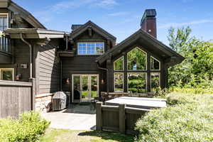 Rear view of house featuring a patio area, french doors, and a chimney