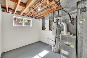 Basement with gas water heater and electric panel