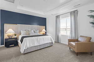 Bedroom featuring carpet flooring and a tray ceiling