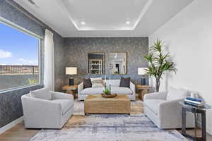 Living area featuring wood finished floors, recessed lighting, and wallpapered walls