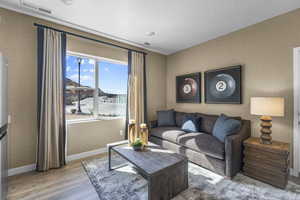 Living area featuring baseboards and wood finished floors