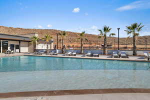 Community pool with a patio area and a mountain view