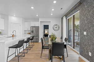 Dining space featuring recessed lighting and light wood-style flooring