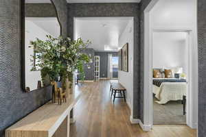 Corridor featuring wood finished floors and baseboards