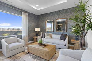 Living room with a tray ceiling and recessed lighting