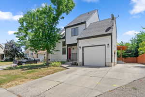 Traditional home featuring an attached garage and concrete driveway