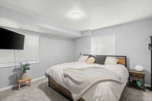 Bedroom featuring carpet flooring and baseboards