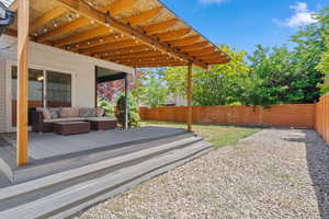 Wooden deck with a fenced backyard and an outdoor hangout area
