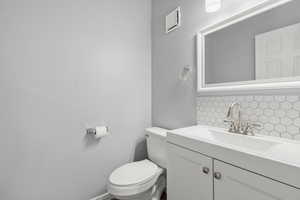 Bathroom with decorative backsplash and vanity