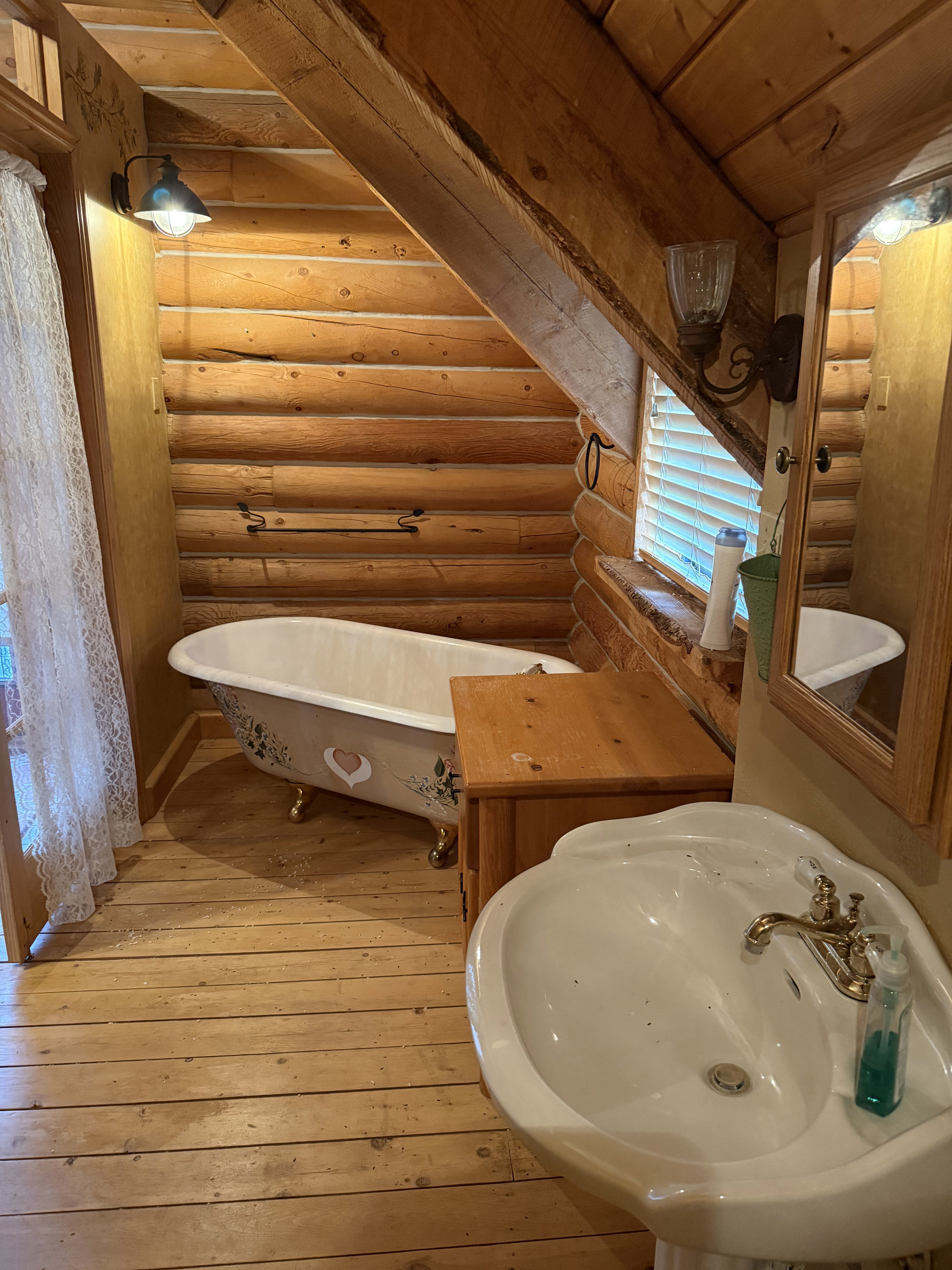 Full bath with rustic walls, a soaking tub, hardwood / wood-style floors, and wooden ceiling