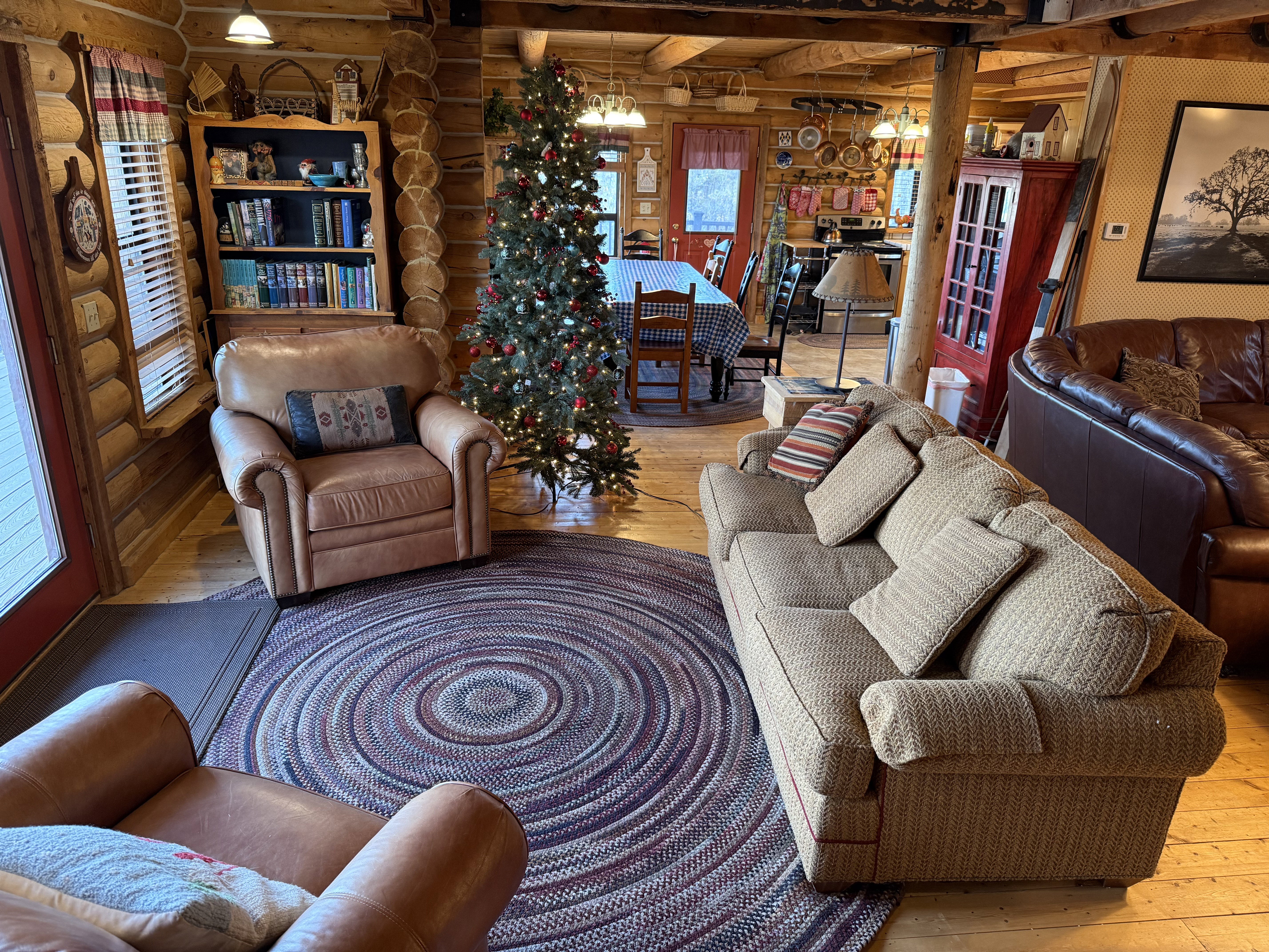 Living room featuring rustic walls, hardwood / wood-style floors, and healthy amount of natural light