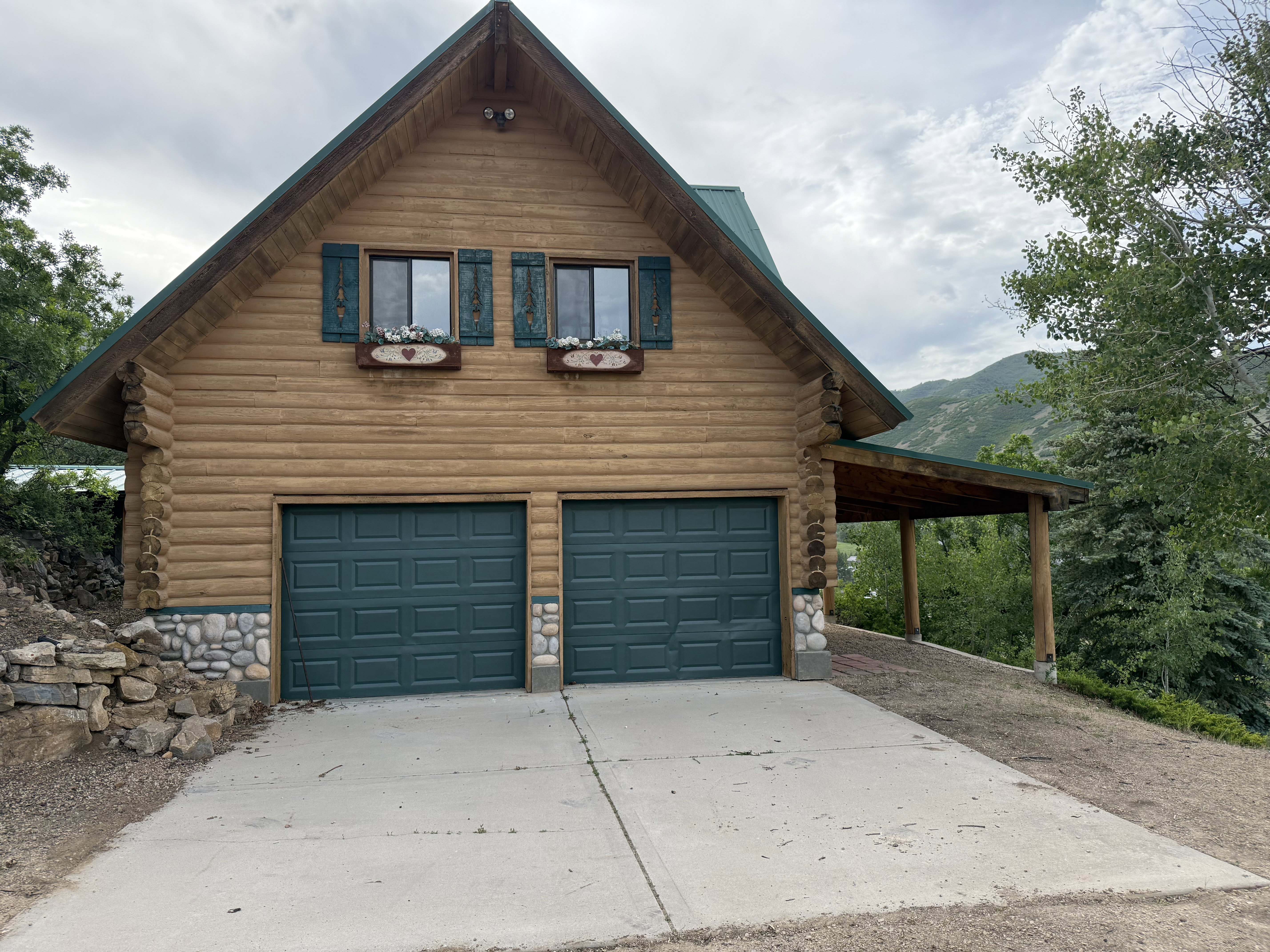 Garage with driveway and a mountain view