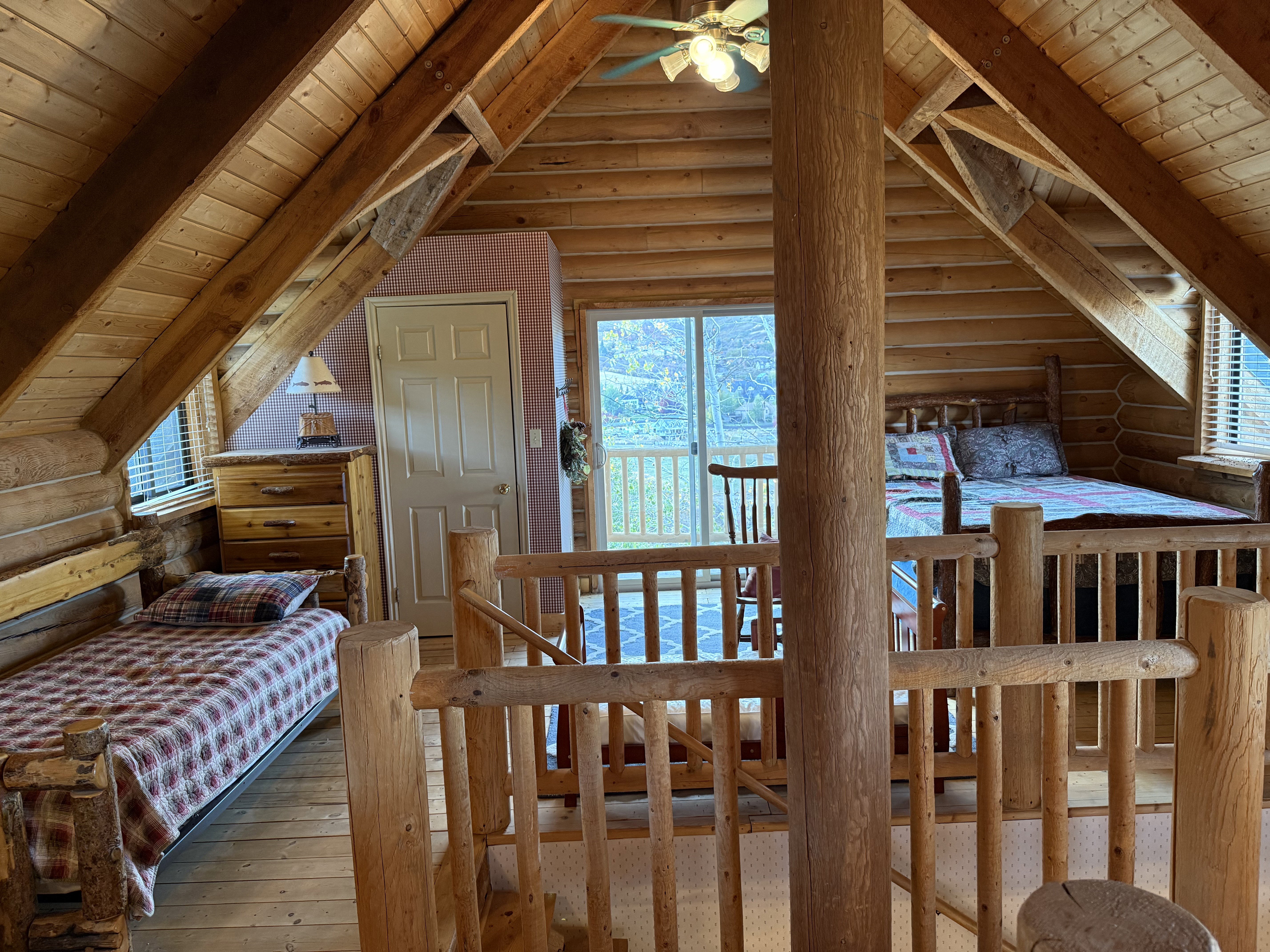 Bedroom featuring rustic walls, wood ceiling, wood-type flooring, and multiple windows