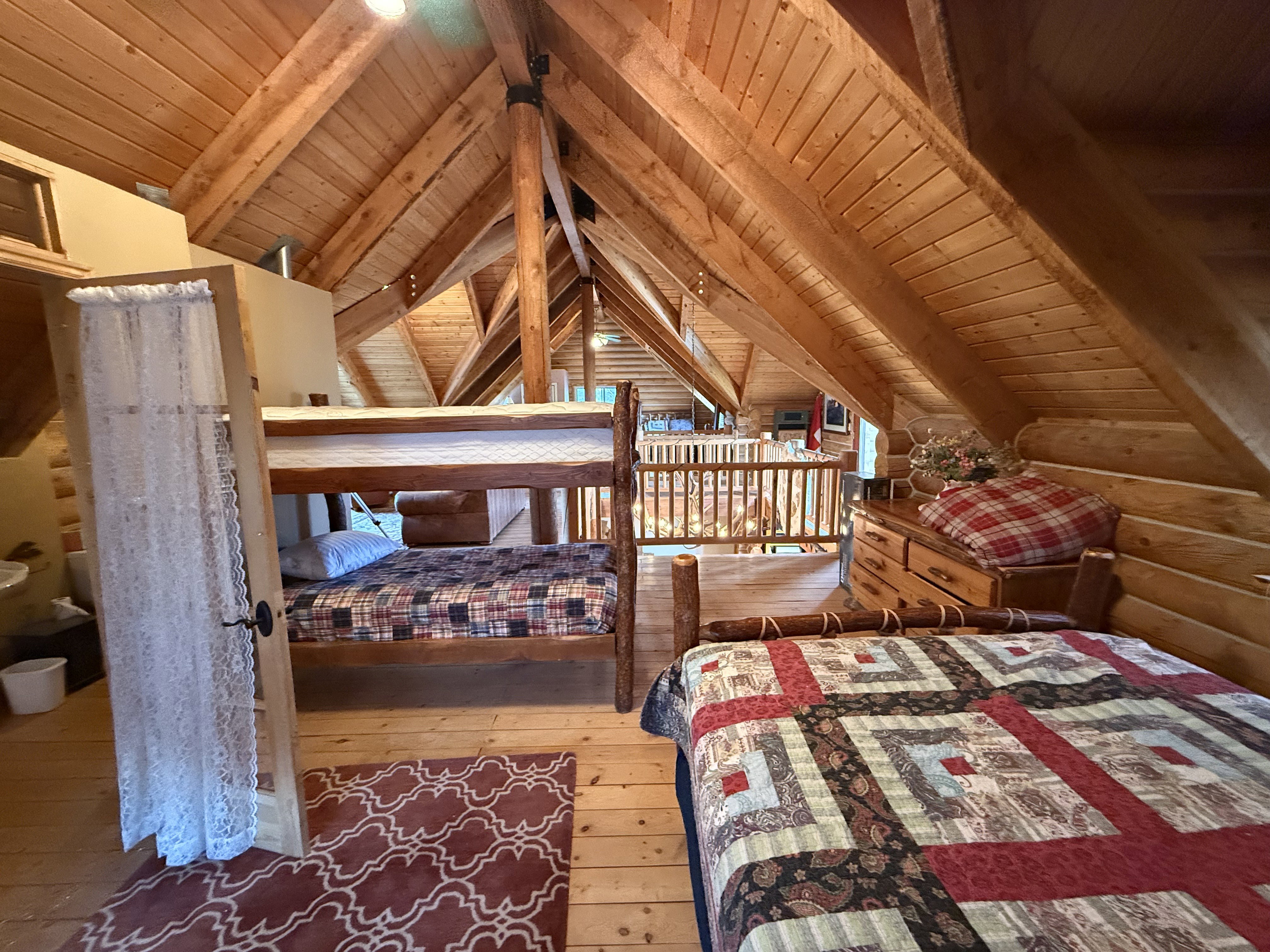 Bedroom featuring wood ceiling, wood-type flooring, and log walls