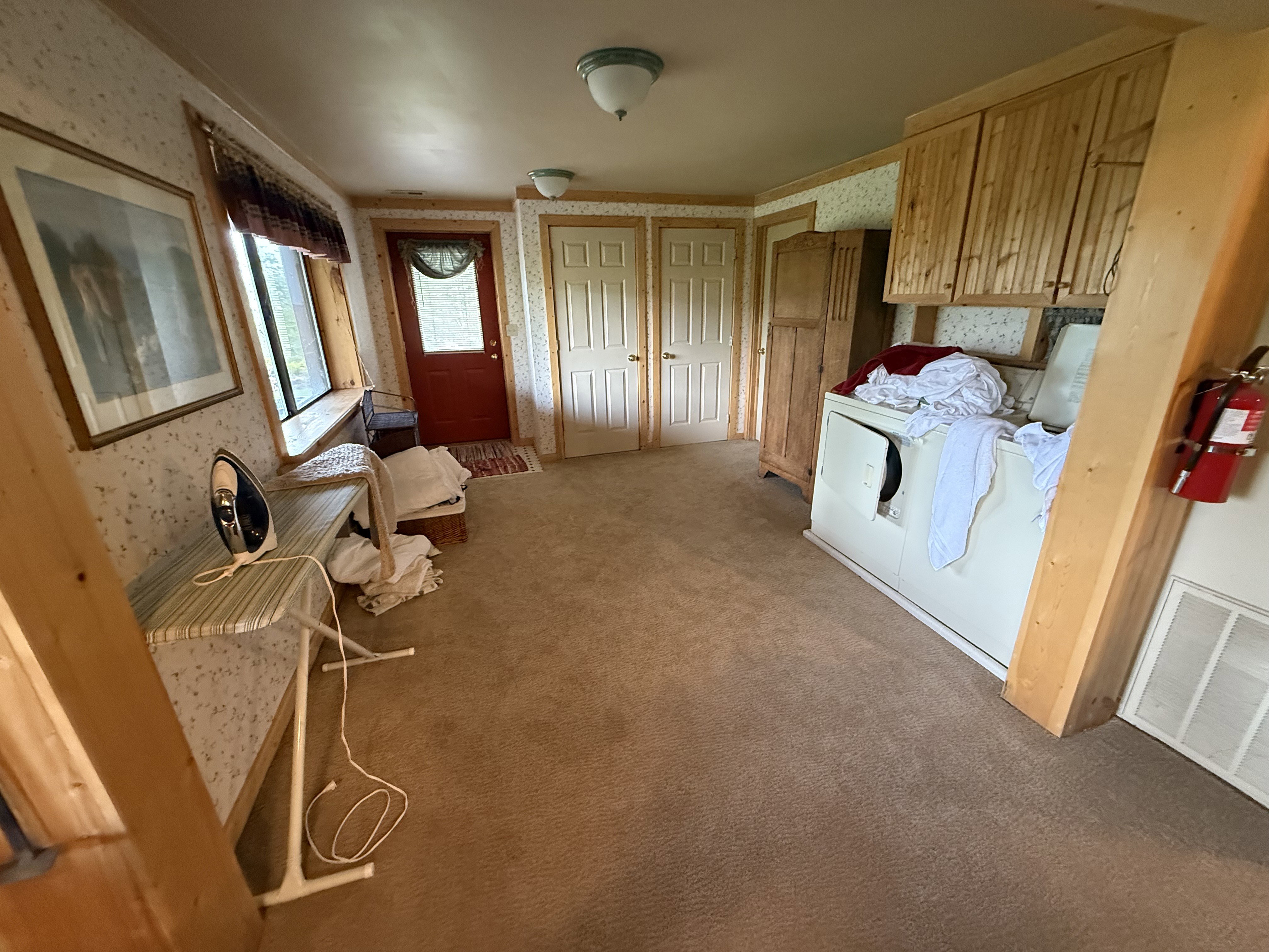 Kitchen featuring wallpapered walls and carpet