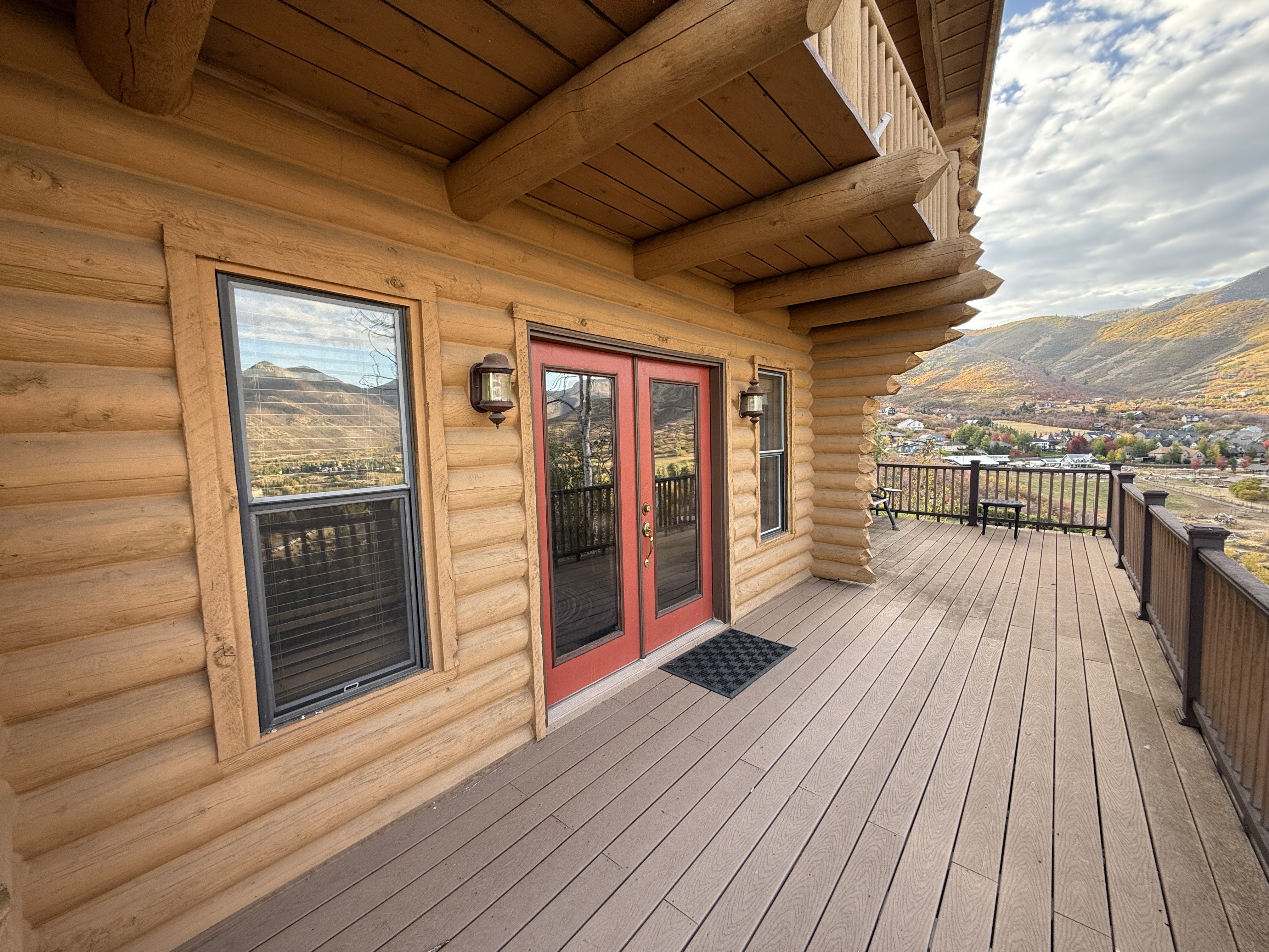 Wooden deck with a mountain view and french doors