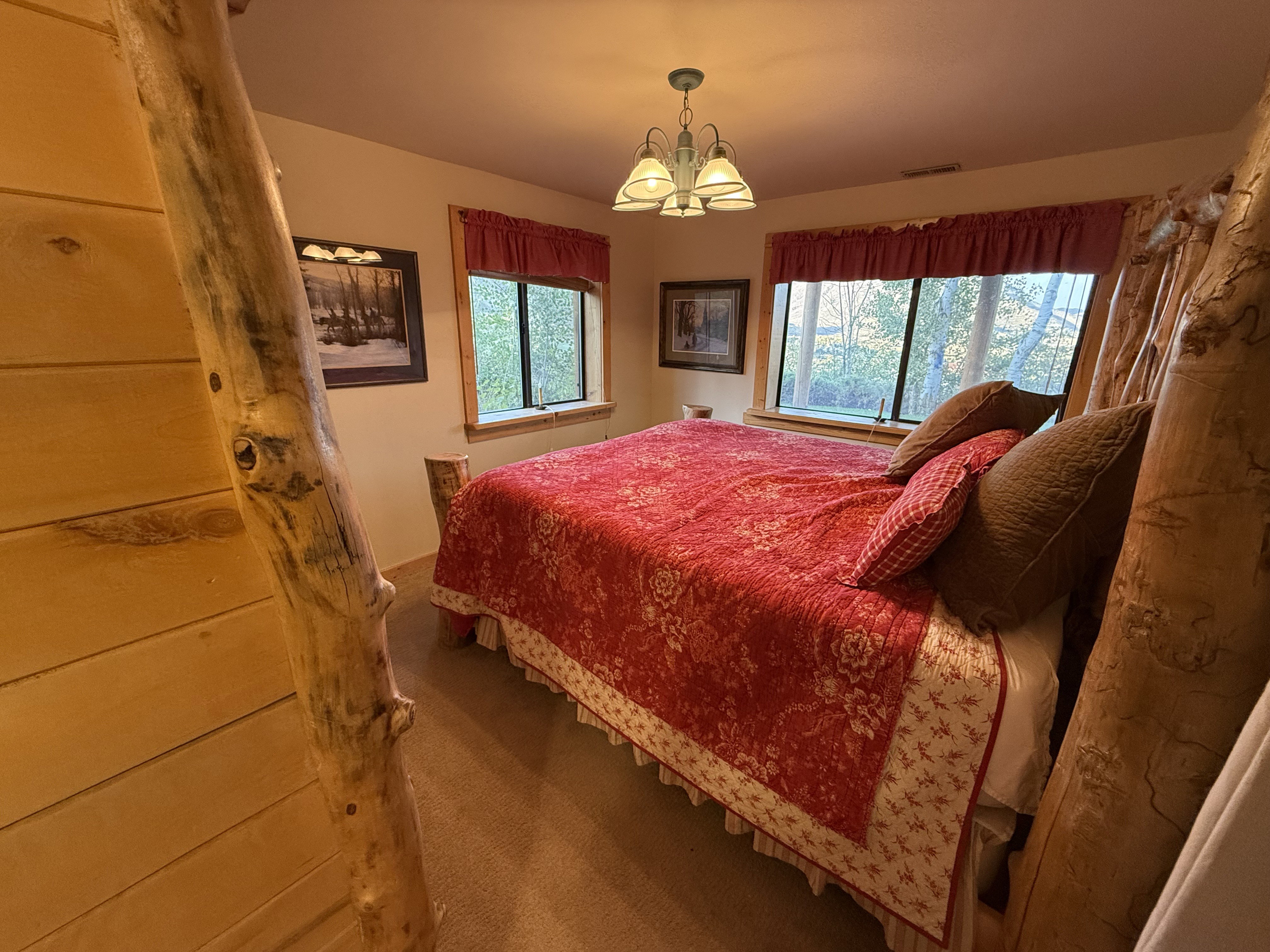 Carpeted bedroom with a chandelier