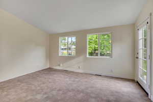 Large family room with access to patio and backyard