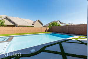 View of pool with a fenced backyard and a patio