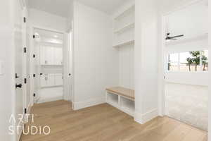 Mudroom with light wood-style flooring and ceiling fan