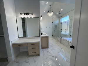 Full bathroom featuring a marble finish shower, a bath, vaulted ceiling, vanity, and light marble finish floors