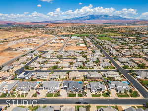 Aerial view of property's location with nearby suburban area and mountains