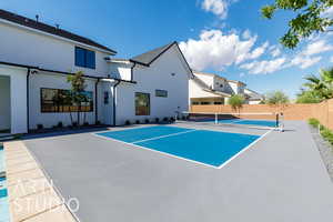 View of tennis court with a patio and a residential view