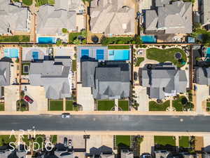 Aerial perspective of suburban area featuring a pool area