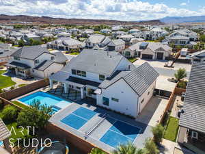 Aerial view of residential area with mountains and a pool area
