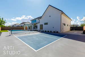 View of tennis court featuring a residential view