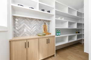 Detailed view of wood finished floors and decorative backsplash