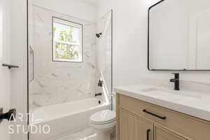 Full bathroom with tub / shower combination, vanity, and marble look tile flooring