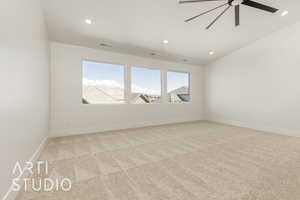 Empty room featuring recessed lighting, light colored carpet, ceiling fan, and vaulted ceiling