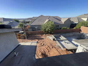 Fenced backyard with a residential view and a patio area