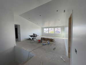 Empty room with lofted ceiling