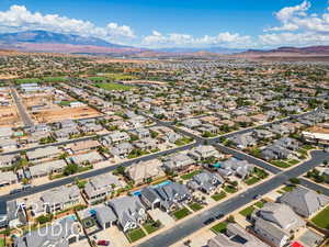 Aerial overview of property's location featuring a mountain backdrop and nearby suburban area