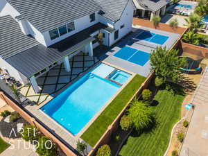 View of swimming pool featuring a pool with connected hot tub and a patio