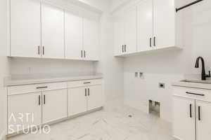 Washroom with cabinet space, washer hookup, light marble finish floors, and electric dryer hookup
