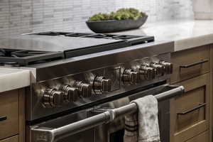 Kitchen view of range with two ovens and decorative backsplash