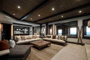 Living area featuring a wood ceiling with exposed beams, recessed lighting, and carpet