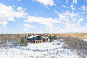 Snow covered house featuring a chimney